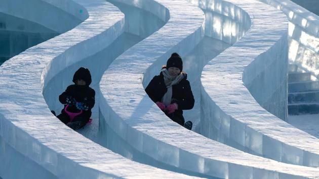 Tourists slide on an ice sculpture at the Harbin Ice and Snow World festival in Harbin. The festival has drawn millions of visitors from around the world every year since its inception in the early 1980s. (NOEL Celis/AFP) Tourists slide on an ice sculpture at the Harbin Ice and Snow World festival in Harbin. The festival has drawn millions of visitors from around the world every year since its inception in the early 1980s. (NOEL Celis/AFP)
