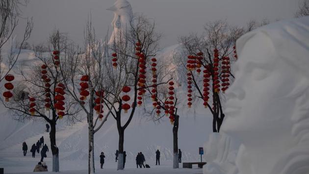 Tourist walk past ice sculpture during the Harbin International Ice and Snow Festival in Harbin. (Noel Celis/AFP) Tourist walk past ice sculpture during the Harbin International Ice and Snow Festival in Harbin. (Noel Celis/AFP)