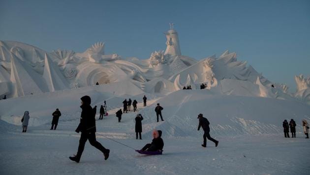 Tourist walk past ice sculptures during the Harbin International Ice and Snow Festival in Harbin. (Noel Celis/AFP) Tourist walk past ice sculptures during the Harbin International Ice and Snow Festival in Harbin. (Noel Celis/AFP)