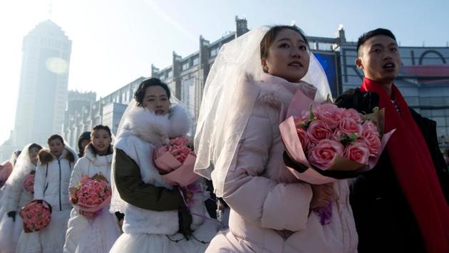 Couples queue up for a "mass ice and snow wedding" ahead of the opening of the Harbin International Snow and Sculpture Festival in Harbin. (Noel Celis/AFP) Couples queue up for a "mass ice and snow wedding" ahead of the opening of the Harbin International Snow and Sculpture Festival in Harbin. (Noel Celis/AFP)