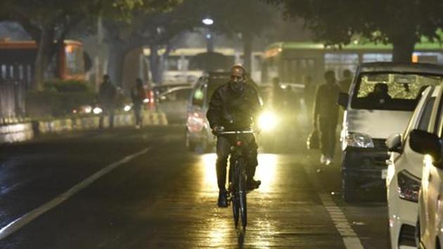 A cyclist out during a light rain shower at Ashoka Road in New Delhi, India on Thursday, December 12, 2019.(Sonu Mehta/HT PHOTO)