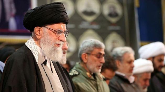 Iran's Supreme Leader Ayatollah Ali Khamenei prays near the coffins of Iranian Major-General Qassem Soleimani, head of the elite Quds Force, and Iraqi militia commander Abu Mahdi al-Muhandis, who were killed in an air strike at Baghdad airport. (VIA REUTERS) Iran's Supreme Leader Ayatollah Ali Khamenei prays near the coffins of Iranian Major-General Qassem Soleimani, head of the elite Quds Force, and Iraqi militia commander Abu Mahdi al-Muhandis, who were killed in an air strike at Baghdad airport. (VIA REUTERS)