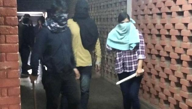 Masked miscreants armed with sticks roaming around campus, at JNU, New Delhi, Sunday. (PTI photo) Masked miscreants armed with sticks roaming around campus, at JNU, New Delhi, Sunday. (PTI photo)