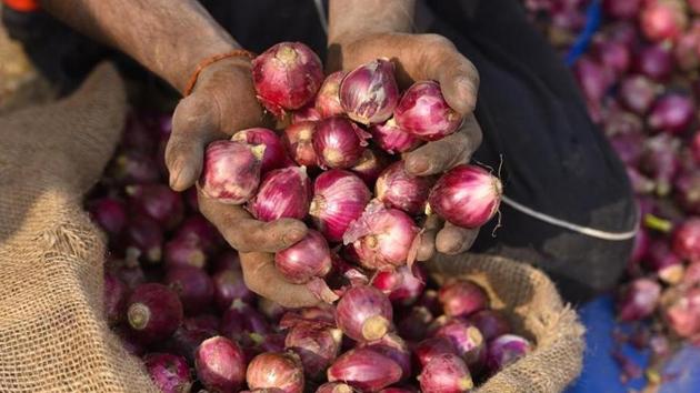 A vegetable vendor displays onions to a customer (PICTURE FOR REPRESENTATIONAL PURPOSES ONLY) A vegetable vendor displays onions to a customer (PICTURE FOR REPRESENTATIONAL PURPOSES ONLY)