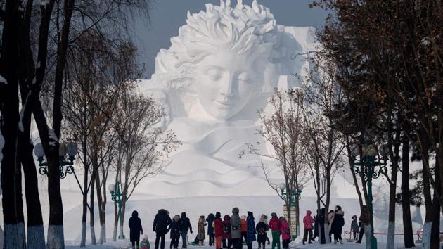 Tourists walk in front of an ice sculpture ahead of the opening of the Harbin International Snow and Sculpture Festival in Harbin. China’s annual ice festival in Harbin has kicked off with couples lining up for a snow-themed mass wedding, swimmers braving frigid waters and frozen palaces rising from the ground. (Noel Celis/AFP) Tourists walk in front of an ice sculpture ahead of the opening of the Harbin International Snow and Sculpture Festival in Harbin. China’s annual ice festival in Harbin has kicked off with couples lining up for a snow-themed mass wedding, swimmers braving frigid waters and frozen palaces rising from the ground. (Noel Celis/AFP)