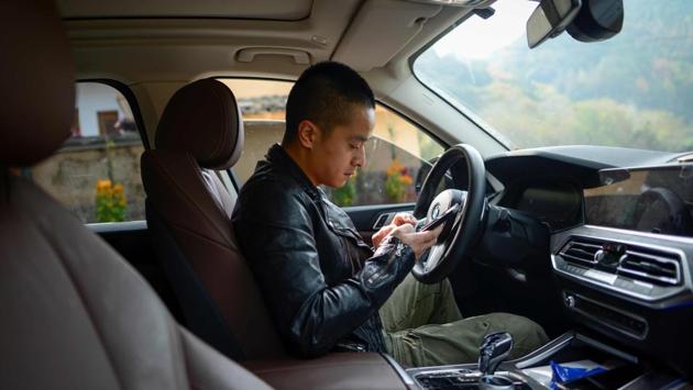 Ma Gongzuo in his car en route to his apiary. He now drives a 4x4 BMW that cost around 760,000 yuan and has also invested in building a B&B. “Using Douyin, that was the turning point,” Ma said. “Today I can buy my family what they need. I help the other villagers to sell their products too. All of the local economy benefits,” he explained. (Wang Zhao/AFP) Ma Gongzuo in his car en route to his apiary. He now drives a 4x4 BMW that cost around 760,000 yuan and has also invested in building a B&B. “Using Douyin, that was the turning point,” Ma said. “Today I can buy my family what they need. I help the other villagers to sell their products too. All of the local economy benefits,” he explained. (Wang Zhao/AFP)