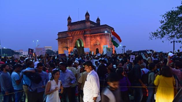 Protesters at Gateway of India on Monday evening. By 9pm on Monday, the number of protesters had shrunk to around 60, in smaller groups that were determined to not disband. Joseph Lobo, a retired teacher from Fergusson College, Pune, said, “As teachers, it is our duty to stand by students.” Anil Karnik, a teacher from the University of Mumbai, said, “I am shocked to see the police allowed a free hand to goons in JNU.” (Vijayanand Gupta / HT Photo) Protesters at Gateway of India on Monday evening. By 9pm on Monday, the number of protesters had shrunk to around 60, in smaller groups that were determined to not disband. Joseph Lobo, a retired teacher from Fergusson College, Pune, said, “As teachers, it is our duty to stand by students.” Anil Karnik, a teacher from the University of Mumbai, said, “I am shocked to see the police allowed a free hand to goons in JNU.” (Vijayanand Gupta / HT Photo)