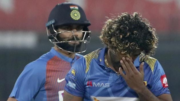 Sri Lanka's captain Lasith Malinga, right, reacts after a shot played by India's captain Virat Kohli.(AP)