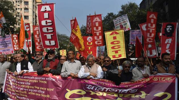 Activists take part in a rally in support of the strike in Kolkata. Incidents of violence and arson were reported from various parts of West Bengal with buses, a police vehicle and government property being vandalised. Clashes also broke out between Left supporters, rallying in support of the strike, and TMC supporters opposing it. (Samir Jana / HT Photo)