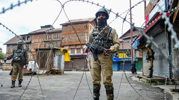 Security personnel stand guard during restrictions in Srinagar.(PTI Photo) Security personnel stand guard during restrictions in Srinagar.(PTI Photo)