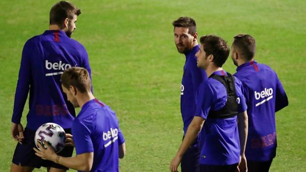 Barcelona's Lionel Messi with teammates during training.(REUTERS)