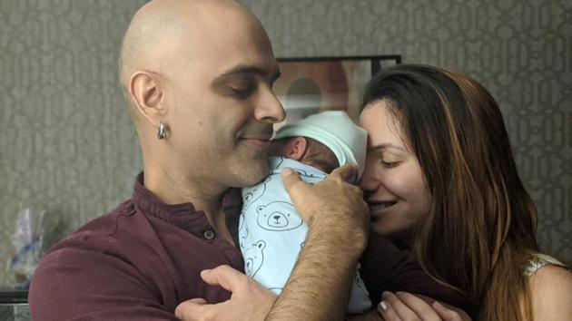 Raghu Ram and his wife Natalie Di Luccio pose with baby Rhythm.