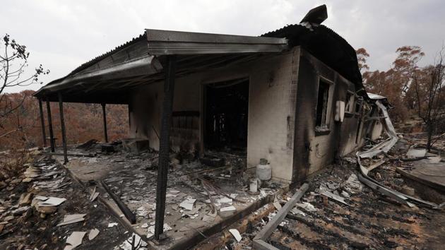 The family’s home gutted home in Balmoral. They escaped —just barely—but found themselves among 2,000 homeowners whose houses have burned down during what has been a catastrophic fire season Down Under, full of apocalyptic images that have focused the world’s attention on climate change. (Rick Rycroft / AP) The family’s home gutted home in Balmoral. They escaped —just barely—but found themselves among 2,000 homeowners whose houses have burned down during what has been a catastrophic fire season Down Under, full of apocalyptic images that have focused the world’s attention on climate change. (Rick Rycroft / AP)