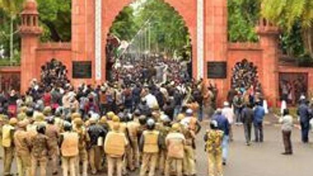 Police personnel stand guard outside Aligarh Muslim University (AMU) as students protest against the passing of Citizenship Amendment Bill, in Aligarh. (PTI file) Police personnel stand guard outside Aligarh Muslim University (AMU) as students protest against the passing of Citizenship Amendment Bill, in Aligarh. (PTI file)