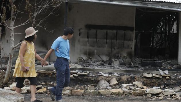 As the family members ran, Wong’s shoes melted and embers landed on her shoulders. She believes they made it out by no more than 30 seconds. The back of their car melted, so they jumped into their truck and drove out. After what might have been five minutes or 10, the fire front moved on and they drove to the fire station, where others were taking shelter. (Rick Rycroft / AP) As the family members ran, Wong’s shoes melted and embers landed on her shoulders. She believes they made it out by no more than 30 seconds. The back of their car melted, so they jumped into their truck and drove out. After what might have been five minutes or 10, the fire front moved on and they drove to the fire station, where others were taking shelter. (Rick Rycroft / AP)