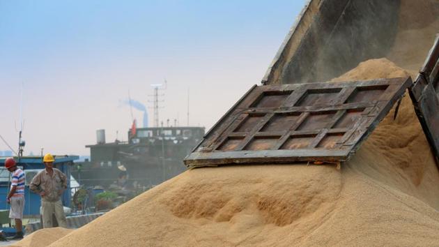 A worker looks on as imported soybeans are transported at a port in Nantong, Jiangsu province, China . (REUTERS) A worker looks on as imported soybeans are transported at a port in Nantong, Jiangsu province, China . (REUTERS)