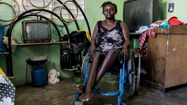 Herlande Mitile, 36, at home in Village Lumane Casimir, northeast of Port-au-Prince. Ten years ago, Mitile was left disabled by the 7.0 magnitude earthquake that devastated Haiti. Today, she uses a wheelchair jury-rigged with a piece of string, which means she cannot go far. She is confined to her village, which itself was meant to be a model for reconstruction of the country after the disaster. (Chandan Khanna/AFP) Herlande Mitile, 36, at home in Village Lumane Casimir, northeast of Port-au-Prince. Ten years ago, Mitile was left disabled by the 7.0 magnitude earthquake that devastated Haiti. Today, she uses a wheelchair jury-rigged with a piece of string, which means she cannot go far. She is confined to her village, which itself was meant to be a model for reconstruction of the country after the disaster. (Chandan Khanna/AFP)