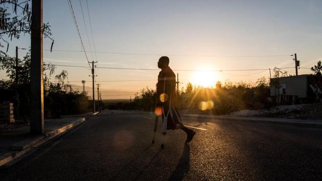 Boulva Verly, 42, who lost a leg during the quake, walks with the help of crutches. Despite some benefits, including the absence of gang violence, Village Lumane Casimir is nevertheless geographically isolated and without any officials to run it. That puts its most vulnerable residents at even higher risk. “Before January 12 (the quake), we got by, but now, I’m worse than a baby,” Mitile said. (Chandan Khanna/AFP) Boulva Verly, 42, who lost a leg during the quake, walks with the help of crutches. Despite some benefits, including the absence of gang violence, Village Lumane Casimir is nevertheless geographically isolated and without any officials to run it. That puts its most vulnerable residents at even higher risk. “Before January 12 (the quake), we got by, but now, I’m worse than a baby,” Mitile said. (Chandan Khanna/AFP)