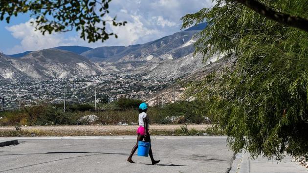 A woman carries bucket of water. Before January 12, 2010, Mitile didn’t know a thing about earthquakes. On that Tuesday, more than 200,000 Haitians were killed, many crushed to death when concrete buildings crumbled on top of them. Mitile was rescued from the debris eight days after the quake. After months in a makeshift camp, Mitile and her two daughters ended up in Village Lumane Casimir. (Chandan Khanna/AFP) A woman carries bucket of water. Before January 12, 2010, Mitile didn’t know a thing about earthquakes. On that Tuesday, more than 200,000 Haitians were killed, many crushed to death when concrete buildings crumbled on top of them. Mitile was rescued from the debris eight days after the quake. After months in a makeshift camp, Mitile and her two daughters ended up in Village Lumane Casimir. (Chandan Khanna/AFP)