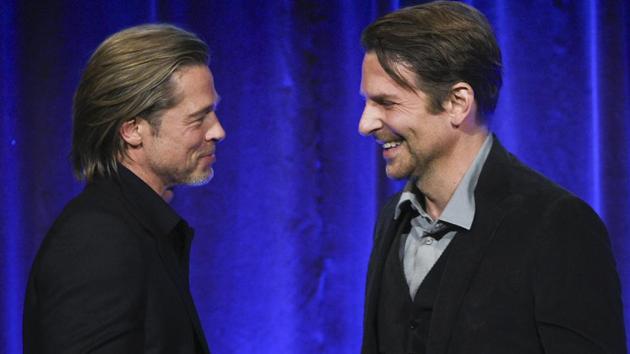 Actor Brad Pitt, left, accepts the best supporting actor award for Once Upon A Time… in Hollywood, from actor Bradley Cooper at the National Board of Review Awards gala.(Evan Agostini/Invision/AP)