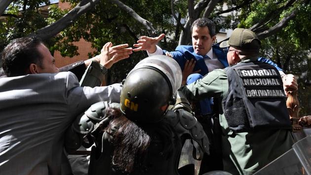 Venezuelan opposition leader and self-proclaimed acting president Juan Guaido (centre right) is blocked by security forces as he tries to reach the National Assembly building in Caracas. Opposition lawmaker Luis Parra --a rival to Juan Guaido--declared himself parliament speaker, as Guaido and fellow opposition lawmakers were blocked from entering the National Assembly. Guaido had been expected to be re-elected to the post but only regime lawmakers and opposition deputies critical of Guaido were allowed to enter. (Federico Parra / AFP) Venezuelan opposition leader and self-proclaimed acting president Juan Guaido (centre right) is blocked by security forces as he tries to reach the National Assembly building in Caracas. Opposition lawmaker Luis Parra --a rival to Juan Guaido--declared himself parliament speaker, as Guaido and fellow opposition lawmakers were blocked from entering the National Assembly. Guaido had been expected to be re-elected to the post but only regime lawmakers and opposition deputies critical of Guaido were allowed to enter. (Federico Parra / AFP)