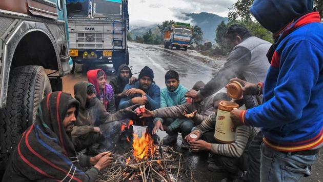 Drivers warm themselves around a bonfire by the roadside, near Swarghat. At least 174 are blocked in Lahaul and Spiti district, 100 in Kullu, 97 in Mandi, 66 in Kinnaur, 52 in Chamba and 43 in Sirmaur. (PTI) Drivers warm themselves around a bonfire by the roadside, near Swarghat. At least 174 are blocked in Lahaul and Spiti district, 100 in Kullu, 97 in Mandi, 66 in Kinnaur, 52 in Chamba and 43 in Sirmaur. (PTI)