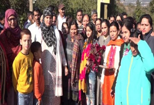 Khushi (garlanded) with her family and teachers at the Government High School, Kawa, in Udhampur district after winning the first prize in the solo vocal music category at the national-level Kala Utsav competition in Bhopal recently.(ANI Photo)