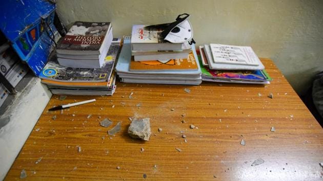 A stone and broken glass are seen inside a room at Sabarmati Hostel after it was vandalised by masked goons. Sabarmati is one of the six university hostels that were attacked by the mob. (Amal KS / HT Photo) A stone and broken glass are seen inside a room at Sabarmati Hostel after it was vandalised by masked goons. Sabarmati is one of the six university hostels that were attacked by the mob. (Amal KS / HT Photo)