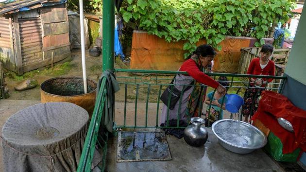 Tyllod Khongwir fills a container from a storage of rain water collected at her home at Nongthymmai-Lumthangding village on the outskirts of Shillong, Meghalaya. Every drop of rain water trickling down Khongwir’s rusty tin roof and into her house is collected. Meghalaya, home to two of the wettest places on earth, is among the greenest states in India but it has rapidly lost its rich rainforests over the last few decades. (Diptendu Dutta / AFP)