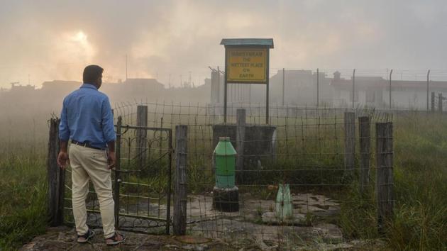 A man stands near a board which reads 'The Wettest Place On Earth' at Mawsynram. Neighbouring Mawsynram village is now officially recognised as the wettest place on earth with close to 12m of rain falling each year, but even there villagers say everything is changing. (Diptendu Dutta / AFP)