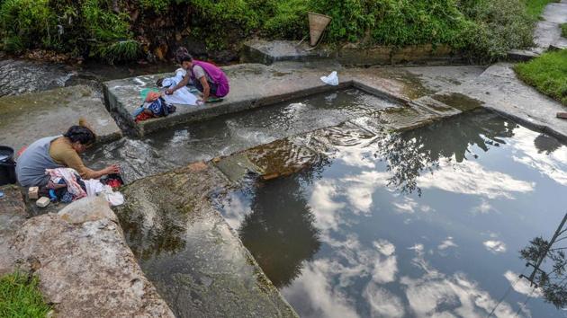Women clean clothes in a stream at Nongthymmai-Lumthangding village on the outskirts of Shillong. Climate change is bringing erratic weather -- flood and drought, sometimes in the same area. Scientists say the monsoons now bring less rain in total, while the demand for water increases as the population, economy, and industry grows. (Diptendu Dutta / AFP)