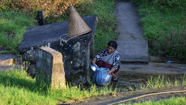 A woman collects drinking water from a steam at Nongthymmai-Lumthangding village. Today the natural springs and aquifers of the area are dwindling -- so residents must save what they can, when they can, and by whatever means they can. The rains come in increasingly violent deluges, but with little storage options, most of the rain is lost as run-off. (Diptendu Dutta / AFP)