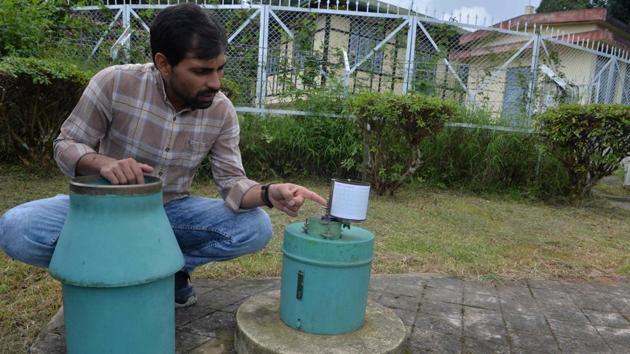 An employee of Shillong Meteorological Department inspects the equipment used to collect data of rainfall and temperature in Shillong. A report by the World Resources Institute warned the nation is facing extremely high water stress, putting the health of hundreds of millions, as well as national development, at risk. (Diptendu Dutta / AFP)
