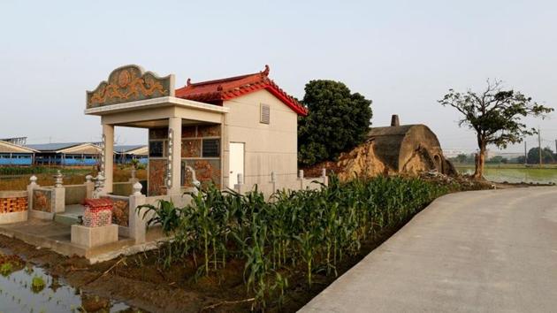 A former air-raid shelter and storage space for the Taiwanese military stands behind a family grave in Kaohsiung, Taiwan. Dotted around Taiwan lie the remains of abandoned bunkers originally built to repel an invasion from China, during a period in the island’s history when it was under martial law and fear of a Chinese attack was a part of daily life. Over the years, these bunkers have been repurposed by the people. (Ann Wang / REUTERS) A former air-raid shelter and storage space for the Taiwanese military stands behind a family grave in Kaohsiung, Taiwan. Dotted around Taiwan lie the remains of abandoned bunkers originally built to repel an invasion from China, during a period in the island’s history when it was under martial law and fear of a Chinese attack was a part of daily life. Over the years, these bunkers have been repurposed by the people. (Ann Wang / REUTERS)