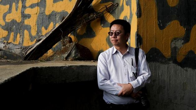 Chen Kuo-ming, 49, a senior editor for a military magazine and a military site enthusiast who has been searching and mapping out old bunkers since 2002, poses for a photo inside a former artillery bunker in Nantou, Taiwan. “I find it very bizarre - across Taiwan there are numerous bunkers, a mark of war, but if you ask residents what is it, when was it built and for what purpose, no one knows now,” said Chen. (Ann Wang / REUTERS) Chen Kuo-ming, 49, a senior editor for a military magazine and a military site enthusiast who has been searching and mapping out old bunkers since 2002, poses for a photo inside a former artillery bunker in Nantou, Taiwan. “I find it very bizarre - across Taiwan there are numerous bunkers, a mark of war, but if you ask residents what is it, when was it built and for what purpose, no one knows now,” said Chen. (Ann Wang / REUTERS)