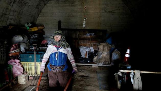 A local farmer who uses a former Taiwanese military air-raid shelter for storage space, moves some of her tools in Kaohsiung. Today, farmers use the retired bunkers as storage rooms for tools, while some have become part of the parks and others along the coast are sought-after spots for photo opportunities by Instagramers seeking “likes” for their sunset views. (Ann Wang / REUTERS) A local farmer who uses a former Taiwanese military air-raid shelter for storage space, moves some of her tools in Kaohsiung. Today, farmers use the retired bunkers as storage rooms for tools, while some have become part of the parks and others along the coast are sought-after spots for photo opportunities by Instagramers seeking “likes” for their sunset views. (Ann Wang / REUTERS)