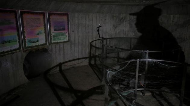 Local Official Lin Zi-Xing's shadow is cast onto the wall of a former bunker in Hsinchu, Taiwan. Recalling how he used to try and sneak into the bunkers as a child to play, Lin said it would be a shame to lose this part of Taiwan’s history. (Ann Wang / REUTERS) Local Official Lin Zi-Xing's shadow is cast onto the wall of a former bunker in Hsinchu, Taiwan. Recalling how he used to try and sneak into the bunkers as a child to play, Lin said it would be a shame to lose this part of Taiwan’s history. (Ann Wang / REUTERS)