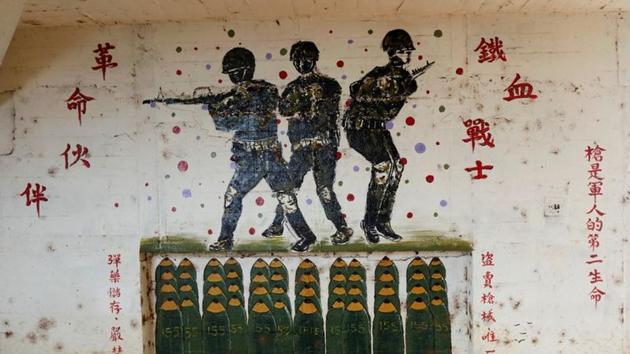 A wall inside a former artillery bunker, painted with soldiers and writing on the right hand side that reads 'Guns is the second life of a soldier' stands in Shuang Lian Po Park, a former military zone in Taoyuan, Taiwan. Military enthusiast Chen said the bunkers also serve as a reminder that tensions between China and Taiwan still exist. “Let’s not forget, Taiwan and China are still in a hostile state,” he said. (Ann Wang / REUTERS) A wall inside a former artillery bunker, painted with soldiers and writing on the right hand side that reads 'Guns is the second life of a soldier' stands in Shuang Lian Po Park, a former military zone in Taoyuan, Taiwan. Military enthusiast Chen said the bunkers also serve as a reminder that tensions between China and Taiwan still exist. “Let’s not forget, Taiwan and China are still in a hostile state,” he said. (Ann Wang / REUTERS)
