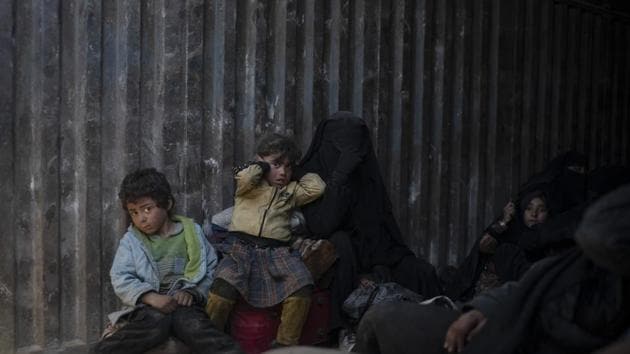 Women and children ride in the back of a truck that is part of a convoy evacuating hundreds out of the last territory held by Islamic State militants in Baghouz, Syria. (AP) Women and children ride in the back of a truck that is part of a convoy evacuating hundreds out of the last territory held by Islamic State militants in Baghouz, Syria. (AP)