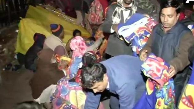 Youth Congress workers distributed blankets among needy and underprivileged, outside All India Institute of Medical Science, Delhi on Saturday midnight. (ANI Photo) Youth Congress workers distributed blankets among needy and underprivileged, outside All India Institute of Medical Science, Delhi on Saturday midnight. (ANI Photo)