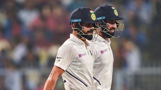 Indian Skipper Virat Kohli with teammate Cheteshwar Pujara(PTI)