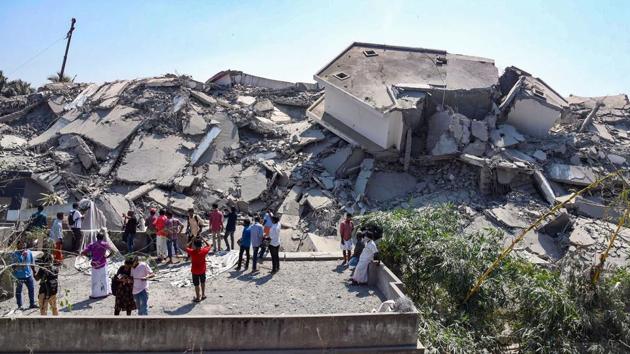 Debris is seen after the demolition as onlookers gather at the site. Officials have said it will take at least one month to clear the nearly 70,000 tonne of rubble after the demolition. Some of the local residents will be allowed to return to their houses after the concrete waste is cleared. (PTI) 