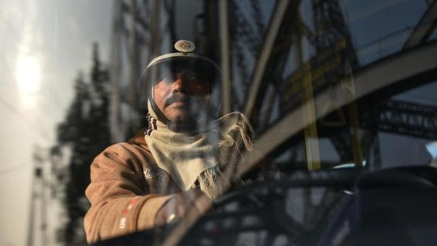 A man drives while wearing a helmet during a nationwide general strike called by trade unions, in Kolkata. (Samir Jana/HT Photo)