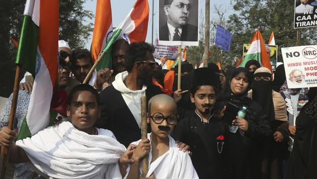 A child dressed like Mahatma Gandhi participates in a protest against the amended citizenship law.(AP)