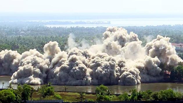 Firemen used water cannons to control dust and fumes that enveloped the whole area of the Maradu complexes after both the buildings came down as thousands gathered to watch the demolition. (ANI) 