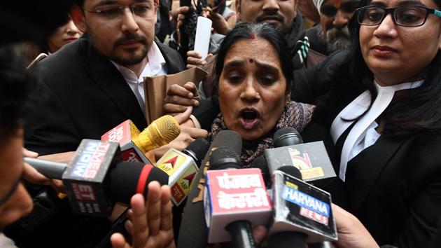 Mother of the 23-year-old physiotherapy student, who was gang-raped seven years ago in Delhi, is surrounded by lawyers as she speaks to the media after the court issued a black warrant to execute the convicts, outside Patiala House Court in New Delhi. (Biplov Bhuyan/HT Photo)