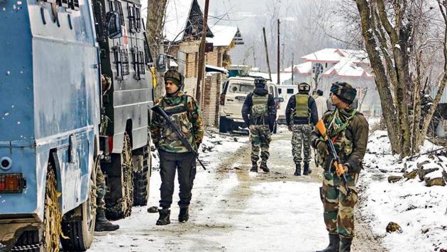 Army personnel take positions near a house where the terrorists were hiding at Gulshanpora in Tral area of south Kashmir on Sunday. (PTI File Photo)