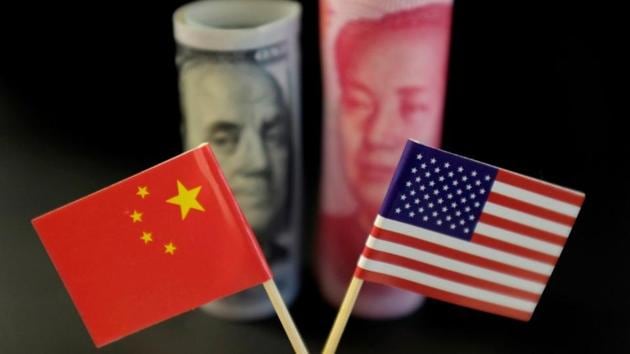 US and Chinese flags are seen in front of a US dollar banknote featuring American founding father Benjamin Franklin and a China's yuan banknote featuring late Chinese chairman Mao Zedong. (Photo: Reuters) US and Chinese flags are seen in front of a US dollar banknote featuring American founding father Benjamin Franklin and a China's yuan banknote featuring late Chinese chairman Mao Zedong. (Photo: Reuters)