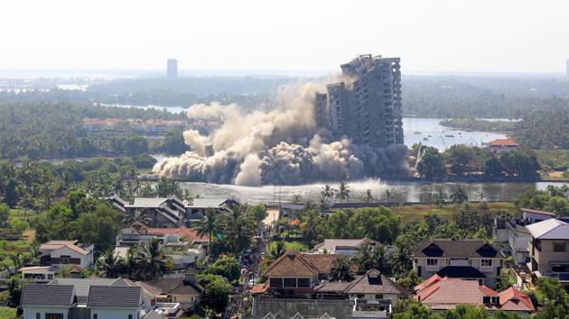 A view of Jain Coral Cove apartment built in violation of Coastal Regulation Zone norms in Maradu Municipality, being demolished through a controlled implosion in Kochi on Sunday.(Vivek R Nair/HT Photo) A view of Jain Coral Cove apartment built in violation of Coastal Regulation Zone norms in Maradu Municipality, being demolished through a controlled implosion in Kochi on Sunday.(Vivek R Nair/HT Photo)