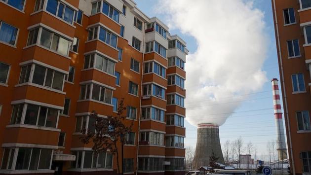 Smoke billows from a cooling tower of a thermal power plant near residential buildings in Hegang. “Many drifted here to buy homes as a fail-safe,” said Li, who paid 750 yuan ($100) per square metre for a top-floor flat in a low-rise housing estate. Apartments in Beijing cost 80 times more. (Ryan Woo / REUTERS) Smoke billows from a cooling tower of a thermal power plant near residential buildings in Hegang. “Many drifted here to buy homes as a fail-safe,” said Li, who paid 750 yuan ($100) per square metre for a top-floor flat in a low-rise housing estate. Apartments in Beijing cost 80 times more. (Ryan Woo / REUTERS)